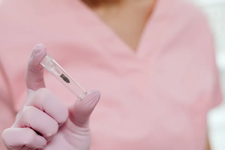 Titanium dental implant component used for long-term replacement of a missing tooth