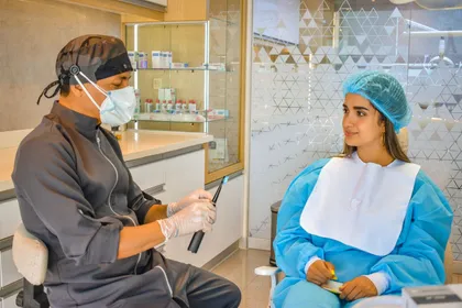 Dentist and patient at a consultation desk reviewing smile design options